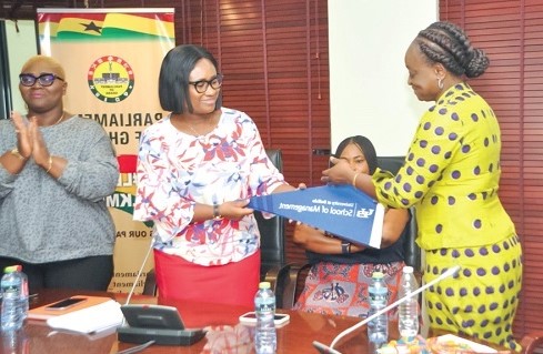 Dr Dorothy Siaw-Asamoah (right) receiving a gift from Effia Tenge,